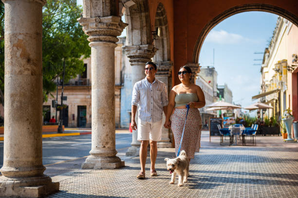 istock Young couple walking with their dog 1474261979