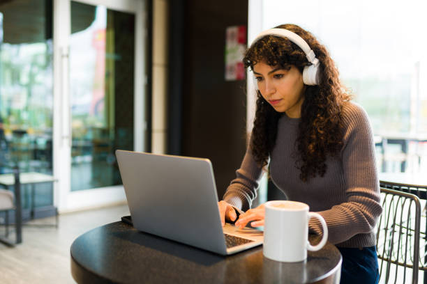 istock Smart woman doing remote work on the laptop while on the coffee shop 1474263143