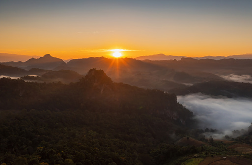 Beautiful aerial view landscape sunbeam with foggy environment during sunrise at morning, Baan jabo viewpoint, Baan JABO one of the most amazing Mist in  Pang Mapha Mae Hong Son Province of Thailand.