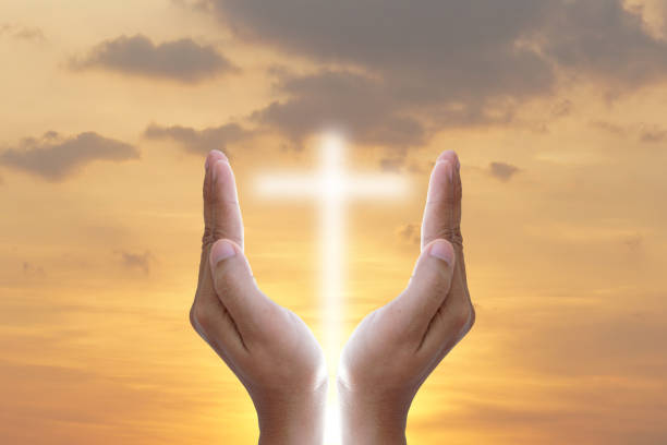 istock Hands bless the cross in the sky. 1474265468
