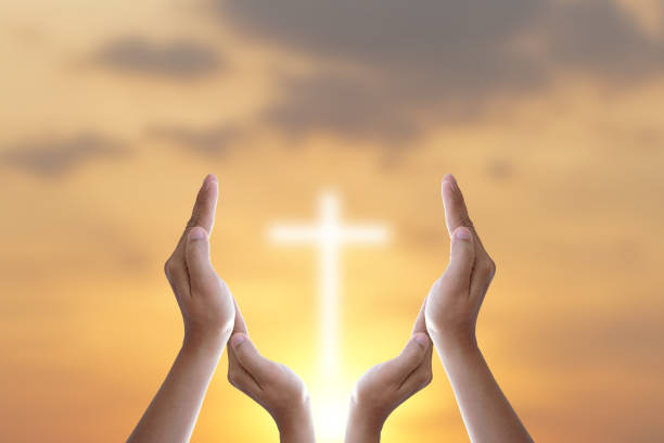 istock Hands bless the cross in the sky. 1474267104