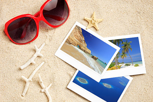 istock Sunglasses, photos, starfish and corals on a beach 147426866