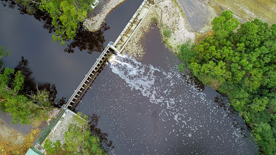 The Keystone Dam in Oklahoma with all the gates open and flowing a lot of water.  Shot at Twilight. 