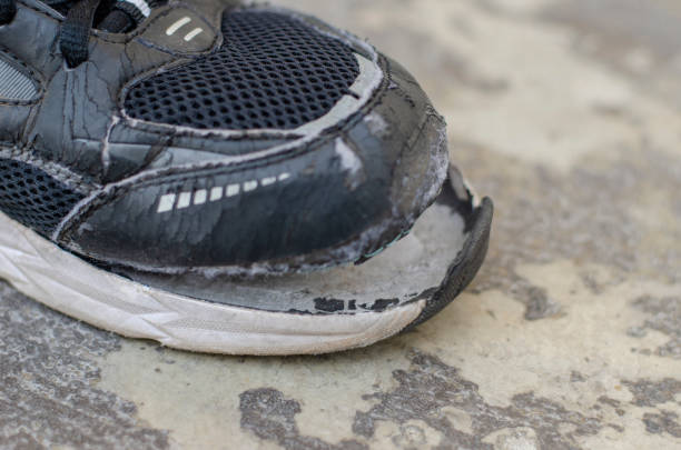 istock closeup view broken old black sneakers on the floor 1474279334