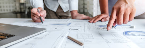 istock Team Engineer drawing graphic planning and meeting for architectural project on workplace 1474280503