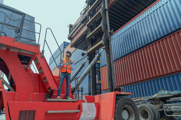 istock Engineers are overseeing the transportation of cargo with containers inside the warehouse. Container in export and import business and logistics. 1474284738