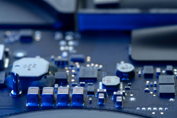 istock Close-up of a computer circuit board, microchips and other elements with soft blue neon lighting 1474284810
