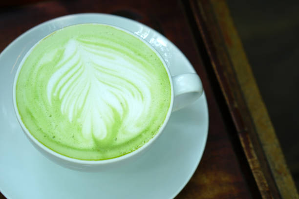 istock hot green tea on wooden floor 1474285446