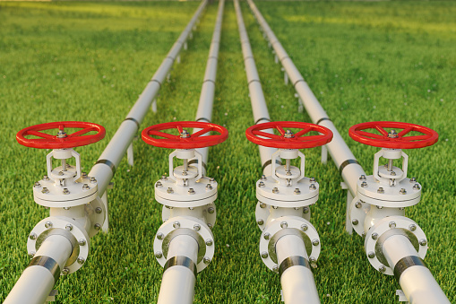 Oil, Gas Or Water Transportation With Pipe Line Valves On Grass