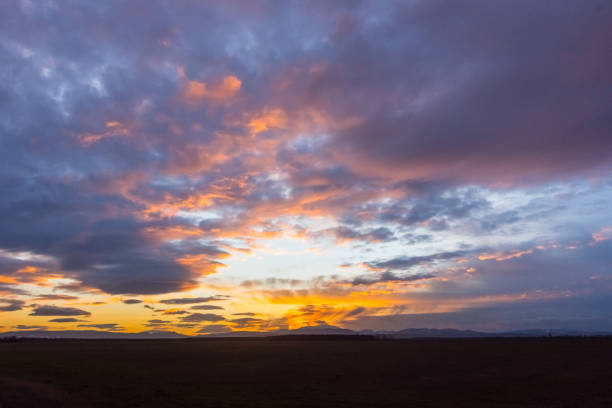 istock blue and colorful clouds at the sky during sundown n a flat landscape 1474290066
