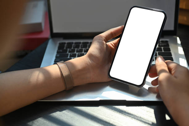 istock Woman hands using mobile phone, chatting on smartphone, using banking services at office desk. Close up view. 1474292419