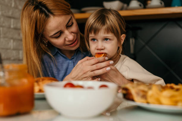 istock Mother and daughter having breakfast in kitchen 1474292694