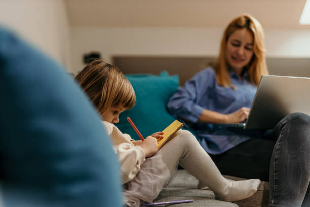 istock Mom is working, daughter is drawing 1474294461