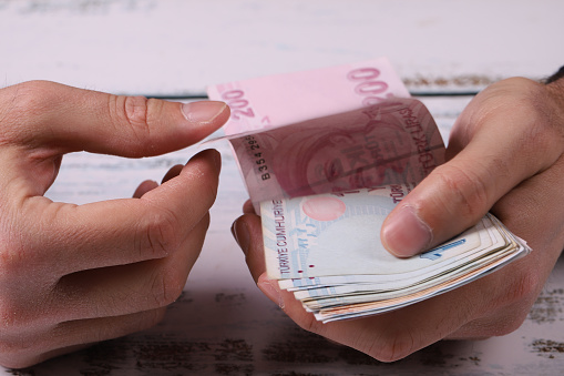 Young man counting Turkish banknotes in his hand. Turkish Lira TRY or TL