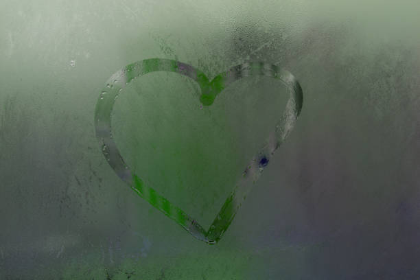 istock Heart on matte green misted glass 1474294993