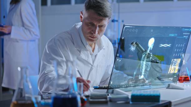 istock Health laboratory worker studying holographic human skeleton image, diagnostics 1474299170