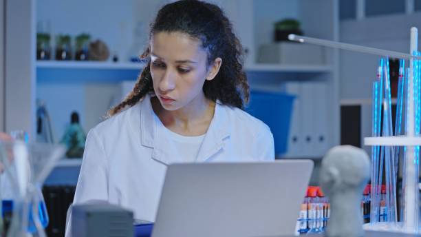 istock Busy scientist examining liquid substance in glass flask, laboratory experiment 1474299229