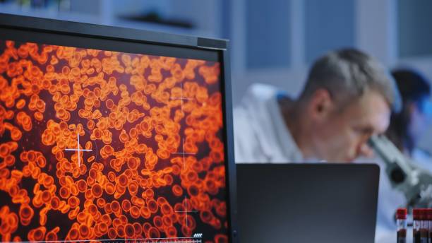 istock Hematology lab scientists examining blood samples under microscope, medicine 1474299296