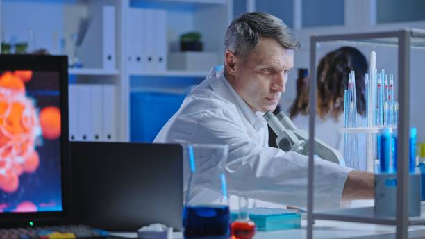 istock Medical laboratory scientist examining infected cell under microscope, research 1474299354