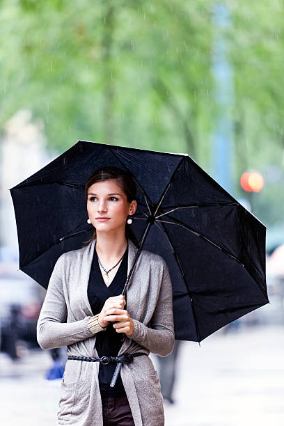 istock Pretty and young woman with umbrella 147430410
