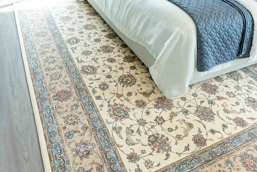 Traditional Arabic woven rug in beautiful blue tone bedroom.