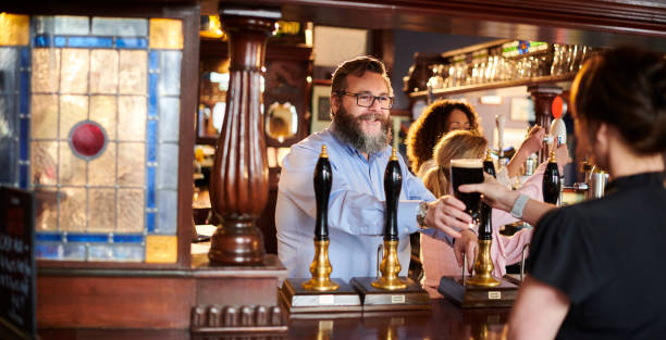 istock pub landlord welcoming customer 1474306525