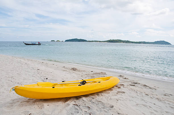 istock Single yellow kayak on the beach 147430862