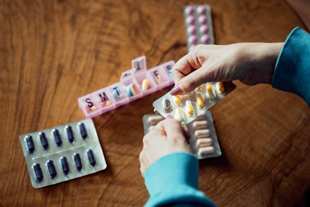istock Unrecognizable mature woman organizing pills into a pill organizer 1474309708