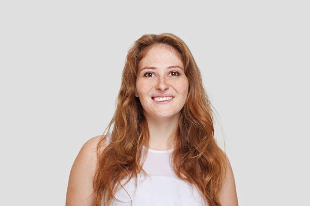 happy lady portrait. young real woman with fresh skin and long ginger hair smiling on white background - cute indoors long hair real people imagens e fotografias de stock