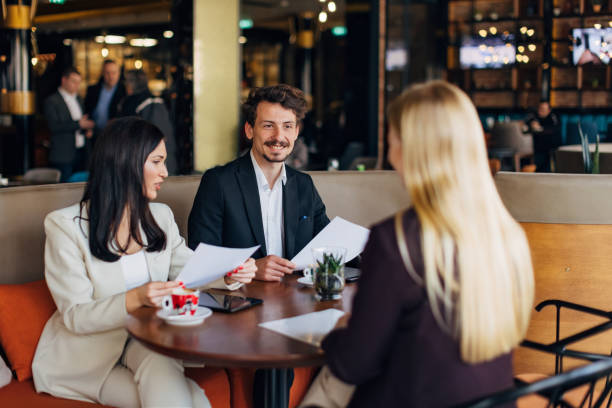 istock A candidate at a job interview with two cheerful entrepreneurs, the job interview is held in a restaurant 1474311671
