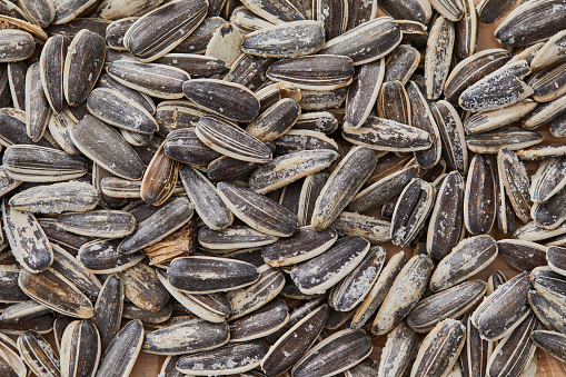 Natural organic healthy black sunflower seed, food macro texture background, representing a healthy lifestyle, wellbeing and body care, top view with a large copy space area
