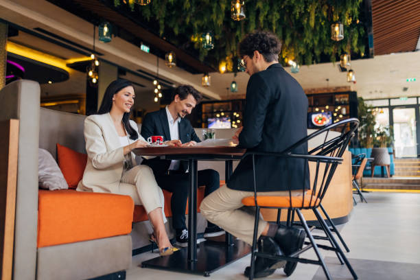 istock Two entrepreneurs interview a male candidate and read his CV 1474311984