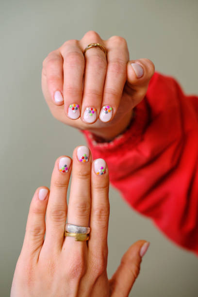 close-up shot of two hands with painted nails
