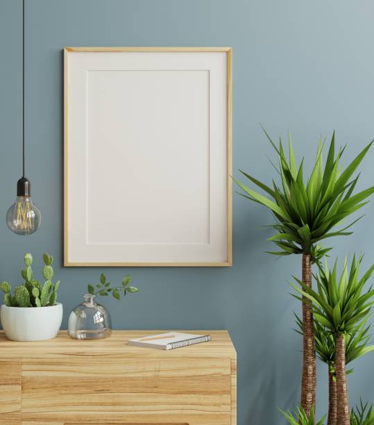 istock Mockup frame on cabinet in living room interior on empty dark blue wall background. 1474326064
