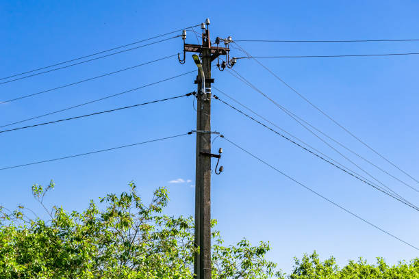 Power electric pole with line wire on colored background close up