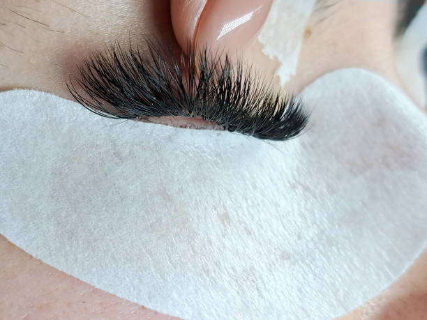 close up of eyelash extensions in beauty salon macro eye close up of eyelash extensions in beauty salon macro eye ,2d volume 3d volume,russian volume, classical style, remover,patches,lash technician,beautician,lashmaker,cat eye clump eyelashes stock pictures, royalty-free photos & images