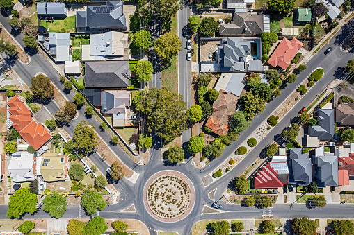 Aerial view of established Adelaide north-eastern suburb looking directly down on houses around Galway Ave with its sparsely landscaped 6-way roundabout (traffic circle). Multi-coloured rooftops some with older red and orange tiles, solar panels installed on some dwellings. Established street trees and home gardens. some powerlines visible. Roads radiating diagonally from roundabout.