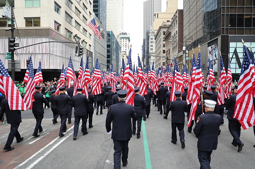 New York, New York - March 17, 2023: Members of the New York City Fire Department Color Guard carry flags and march up Fifth Avenue during the St. Patrick's Day Parade in New York on March 17, 2023. (Photo: Gordon Donovan)