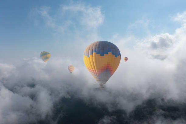 istock Colorful hot air balloon flying above the clouds. 1474330139