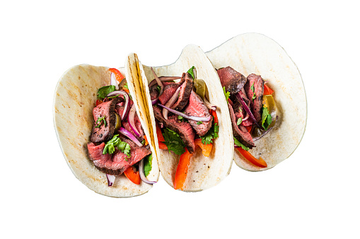 Homemade Mexican Steak Steet Tacos with Cilantro, green sauce, jalapenos and onion.  Isolated on white background.