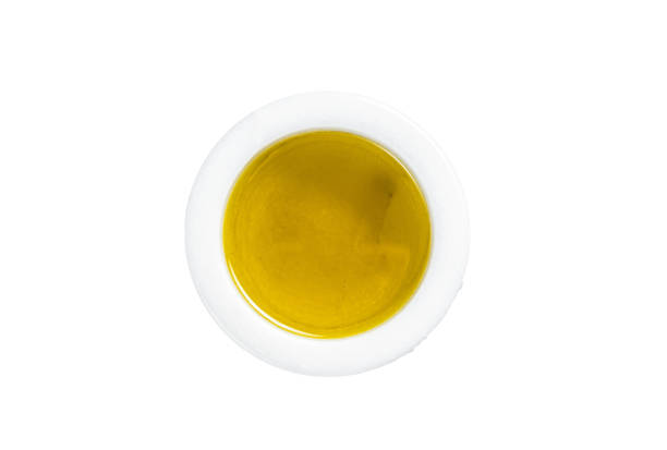 istock Olive oil with fresh herbs on kitchen table.  Isolated on white background. 1474332616