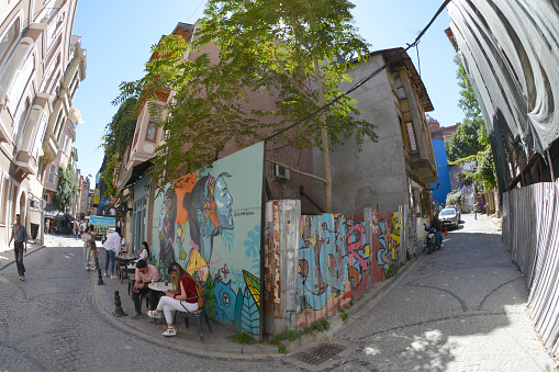 Ljubljana, Slovenia - August 21, 2020: A panorama picture of a building with street art on display at the Metelkova Art Center. The artist's name is Raze.