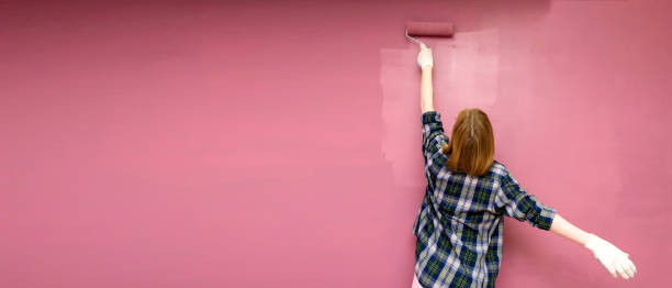 istock Redecorating. Painting walls with paint-roller 1474335023