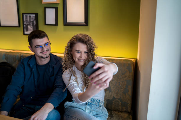 istock Young couple taking a selfie at the restaurant 1474335457