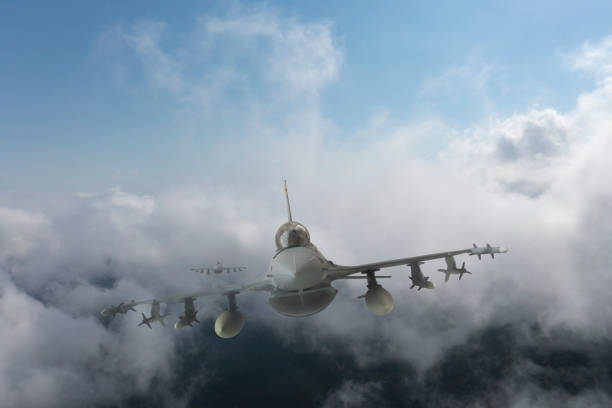 istock Jet aircrafts flying over the clouds. 1474336616