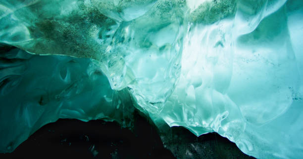 istock The ice under the rocks gradually melts and forms rivers. Turquoise ice. 1474336888