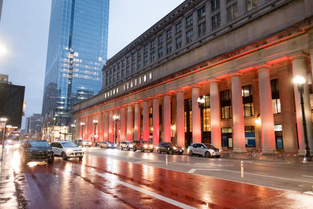 Exterior of Union Station, Chicago, on a wet evening with red reflections from the lighted columns onto the wet roadway. stock photo