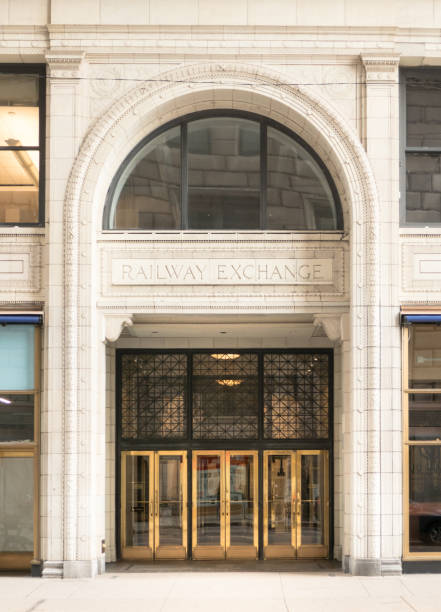 Arched marble entryway to the historic Railway Exchange Building, Chicago, showing arch, sign, and three sets of gold double doors. stock photo
