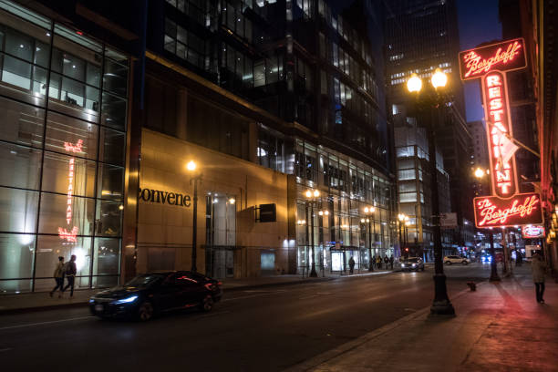 The Berghoff Restaurant, Adams Street, Chicago, at night with lighted neon signs, reflections, and empty street stock photo