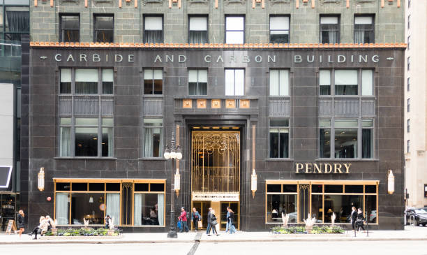 The Carbide and Carbon Building, Chicago, showing exterior, gold trim, and pedestrians walking along the sidewalk. stock photo